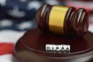 Justice mallet and HIPAA acronym close up. Health insurance portability and accountability act